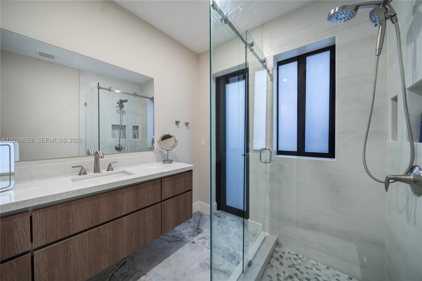 1663 Southwest 13th Street Miami, FL 33145 - Photo 30 of 112 a bathroom with a double vanity sink and mirror