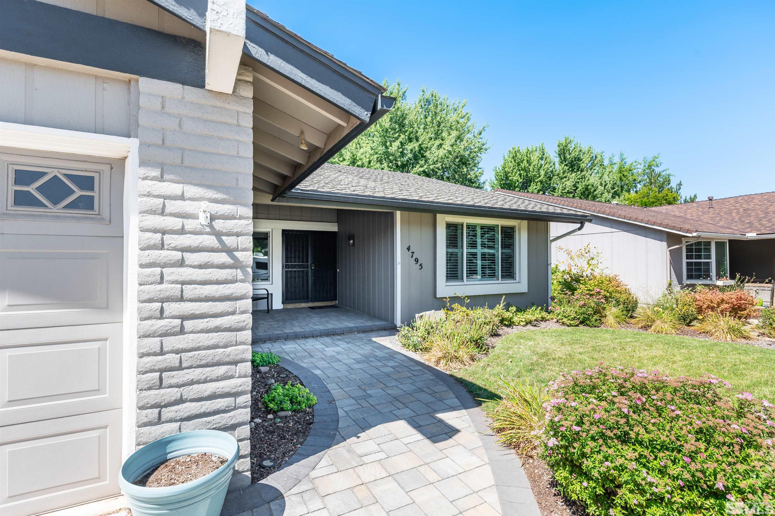 4795 Warren Way Reno, NV 89509 - Photo 2 of 40 a front view of a house with garden