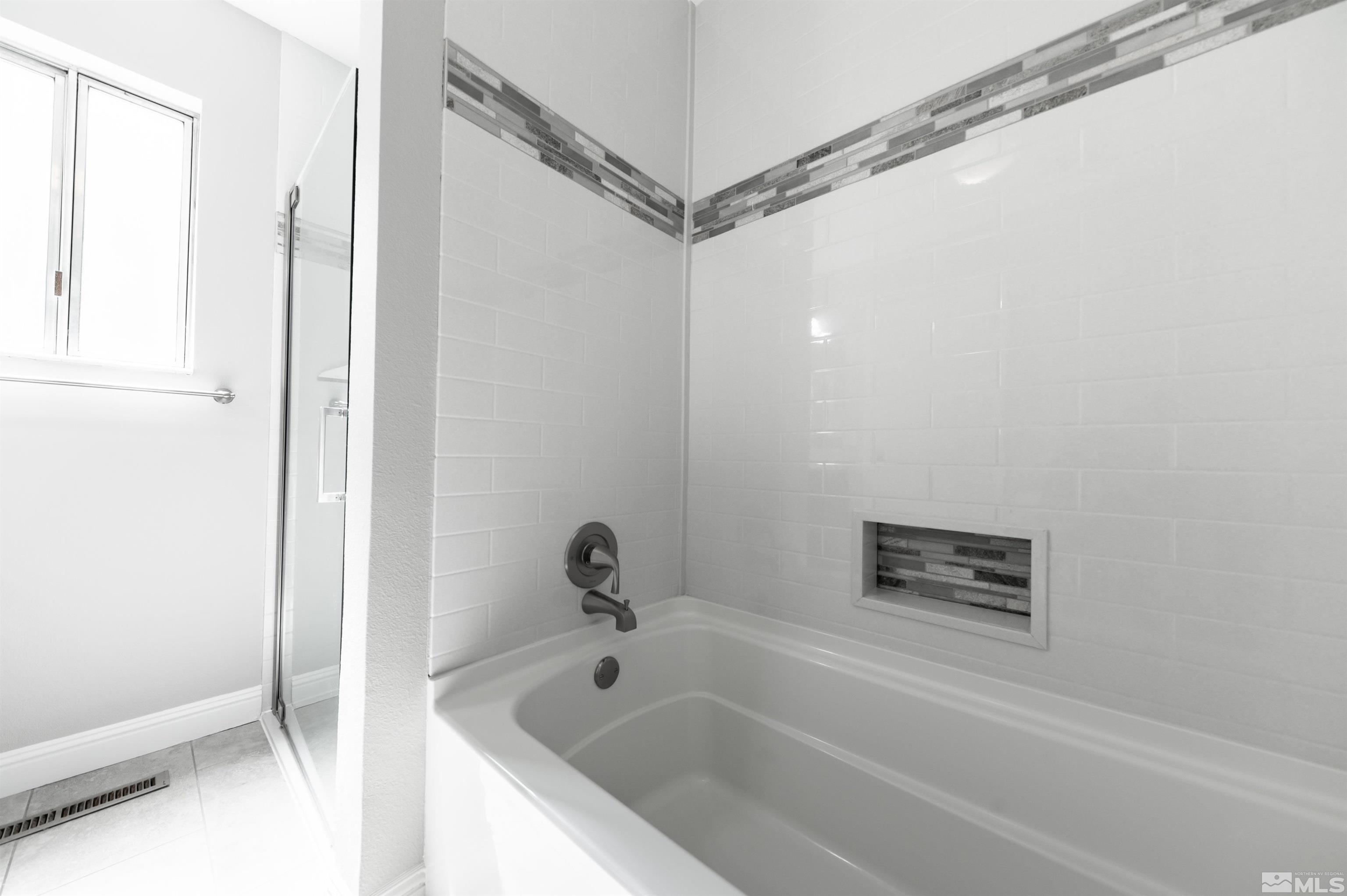 4795 Warren Way Reno, NV 89509 - Photo 21 of 40 a bathroom with a tub and shower