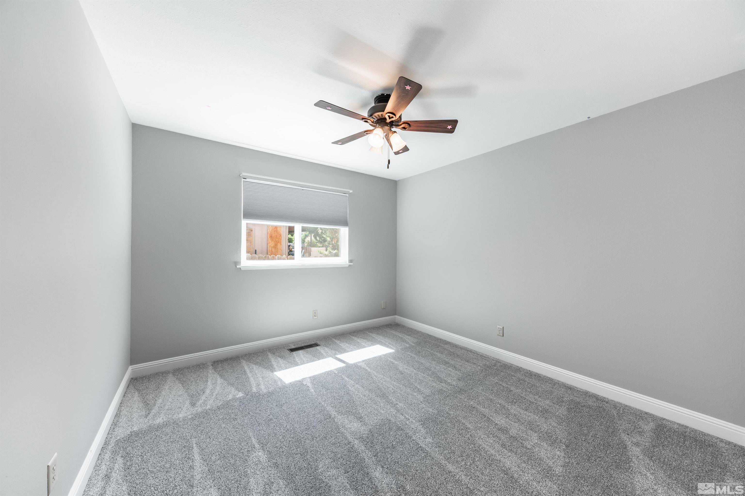 4795 Warren Way Reno, NV 89509 - Photo 24 of 40 an empty room with windows and fan