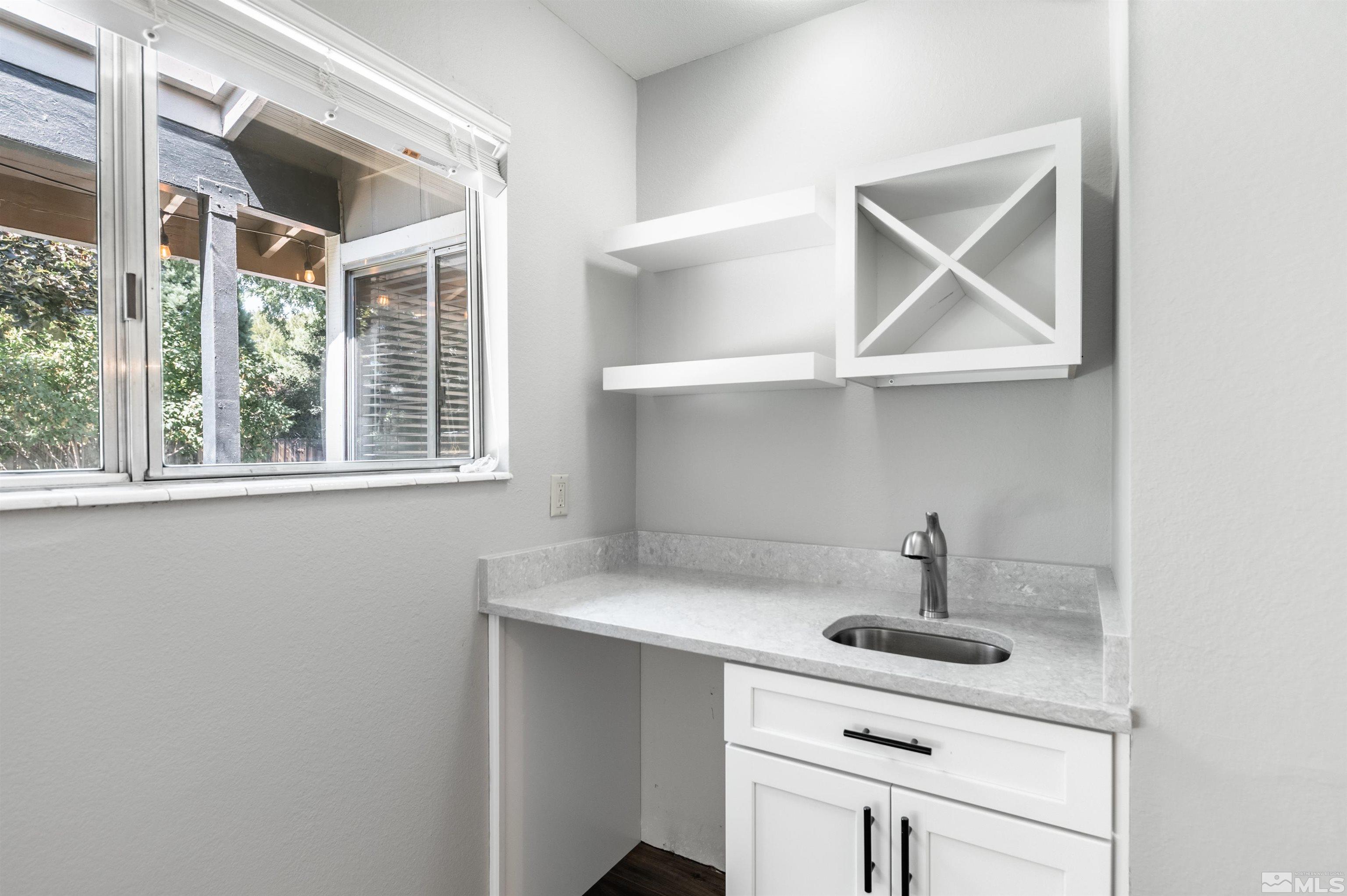 4795 Warren Way Reno, NV 89509 - Photo 9 of 40 a kitchen with a sink a window and cabinets