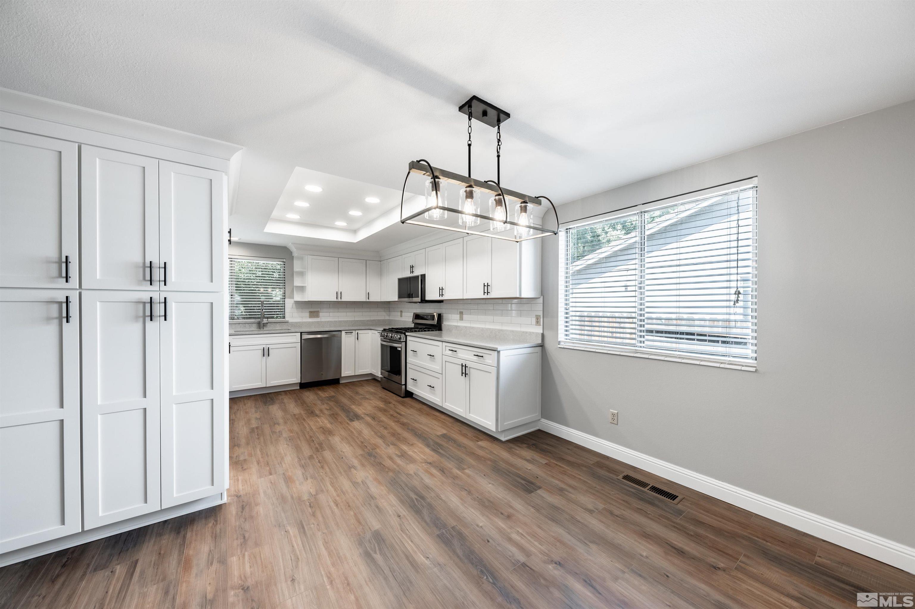 4795 Warren Way Reno, NV 89509 - Photo 10 of 40 a view of a kitchen with a sink cabinets and wooden floor