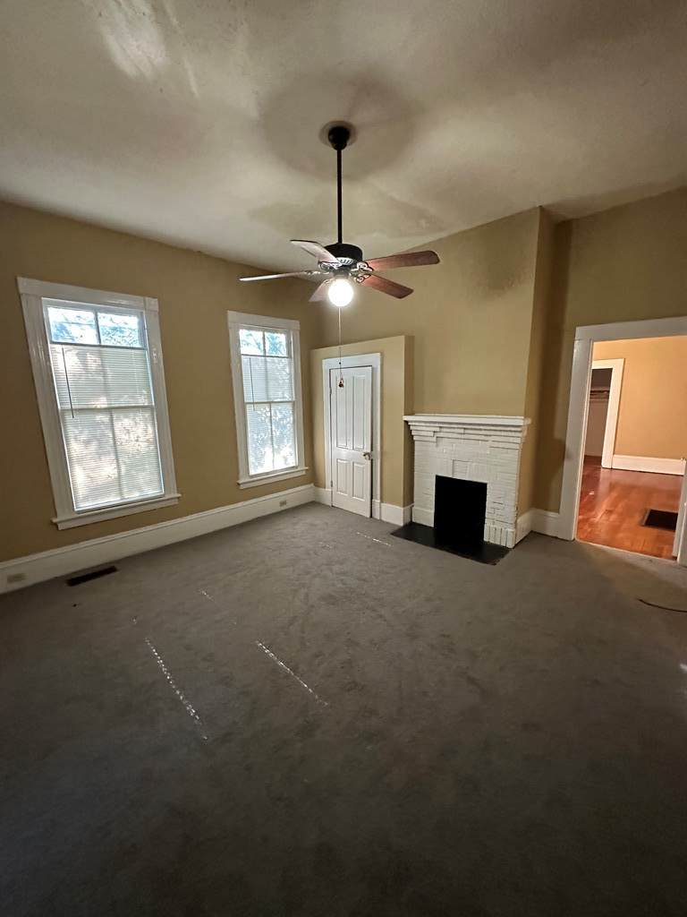 1329 19th Street, Unit B Columbus, GA 31901 - Photo 4 of 5 a furnished livingroom with windows and fireplace