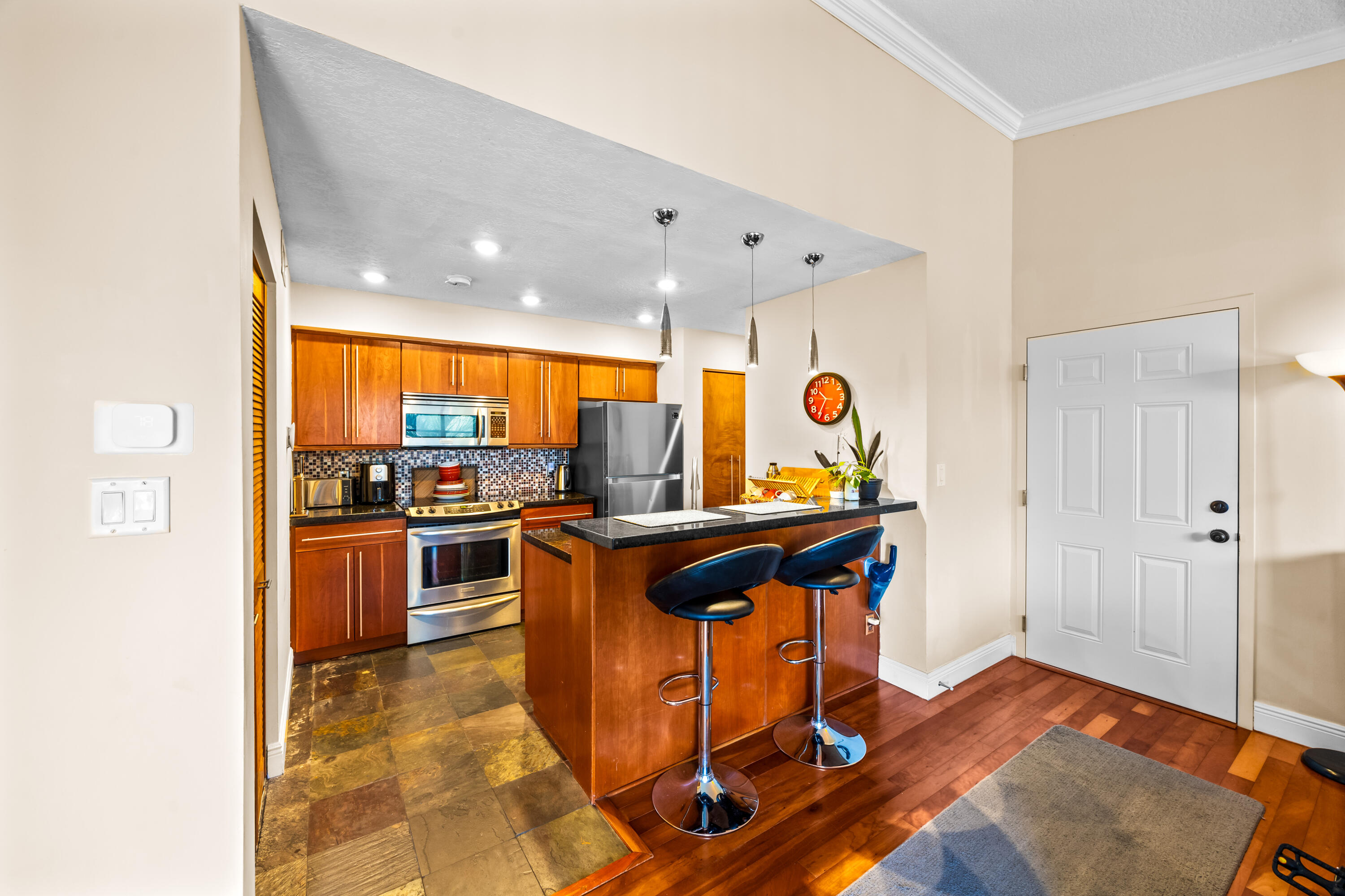 550 South Park Road, Unit 318 Hollywood, FL 33021 - Photo 6 of 27 a view of living room with kitchen island stainless steel appliances wooden floor and view living room