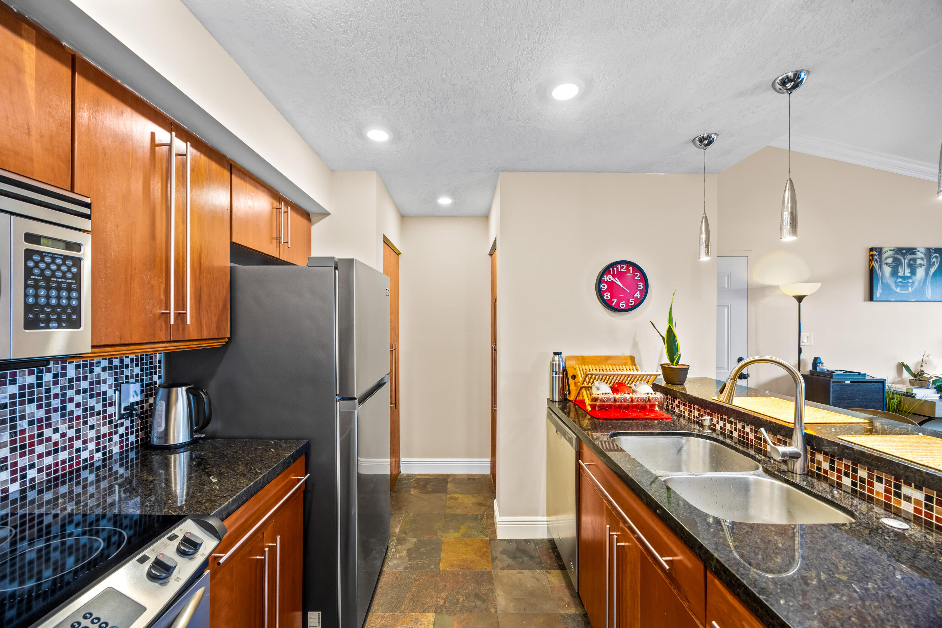550 South Park Road, Unit 318 Hollywood, FL 33021 - Photo 9 of 27 a kitchen with stainless steel appliances granite countertop a sink a stove and a refrigerator