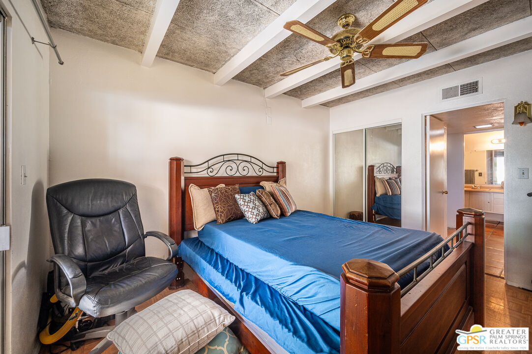 39910 Bird Lane Rancho Mirage, CA 92270 - Photo 13 of 45 a bed room with a bed and a chair