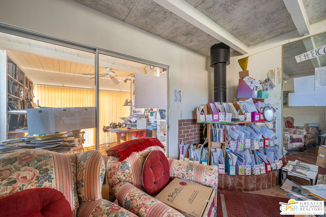 39910 Bird Lane Rancho Mirage, CA 92270 - Photo 14 of 45 a living room with furniture and a floor to ceiling window