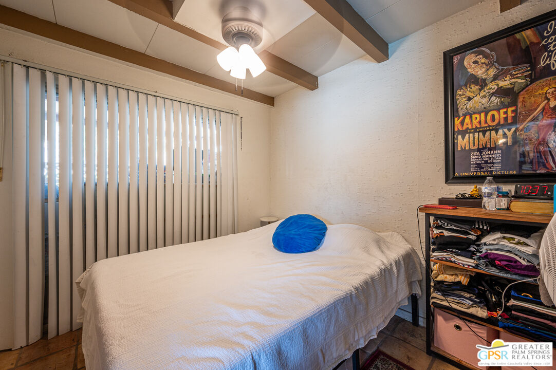 39910 Bird Lane Rancho Mirage, CA 92270 - Photo 20 of 45 a bedroom with a bed and a book shelf