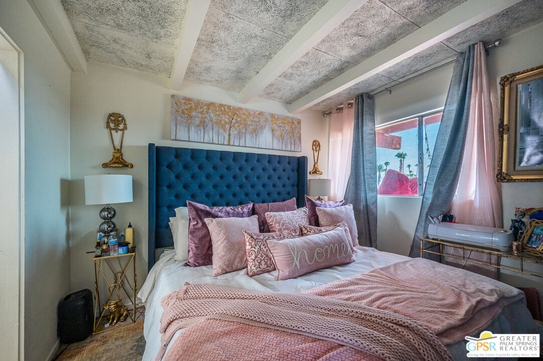 39910 Bird Lane Rancho Mirage, CA 92270 - Photo 23 of 45 a bedroom with a bed wooden floor and window