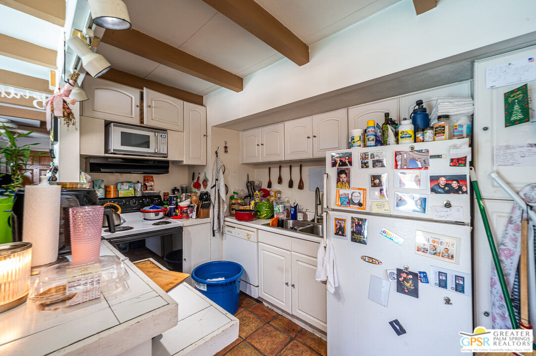 39910 Bird Lane Rancho Mirage, CA 92270 - Photo 30 of 45 a kitchen with a refrigerator and a sink