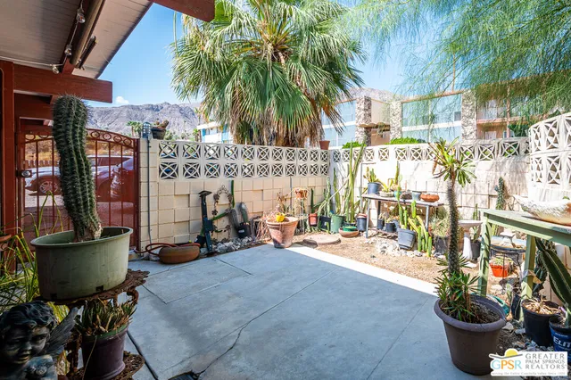 a building outdoor space with patio furniture and potted plants