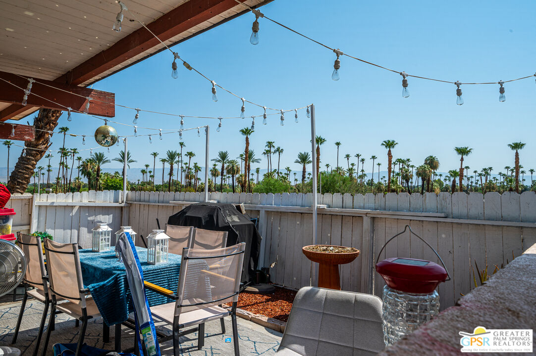 39910 Bird Lane Rancho Mirage, CA 92270 - Photo 32 of 45 a table and chairs in front of a lake