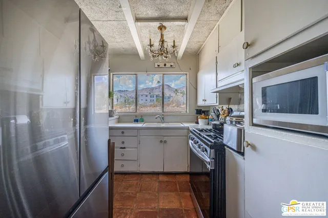 a kitchen with cabinets and window