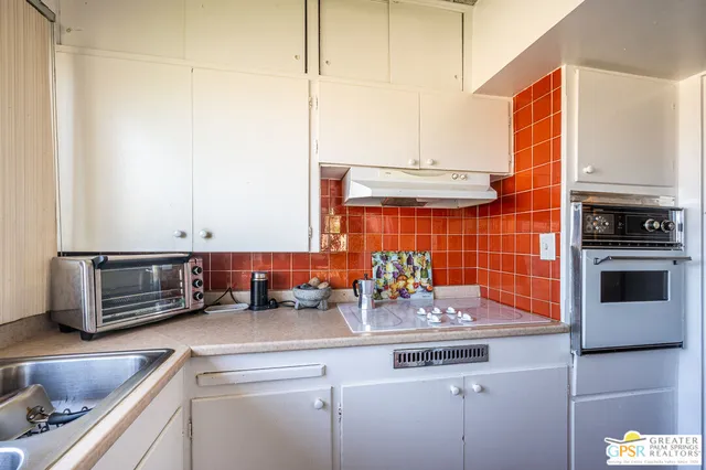 a kitchen with stainless steel appliances a sink a stove and a refrigerator