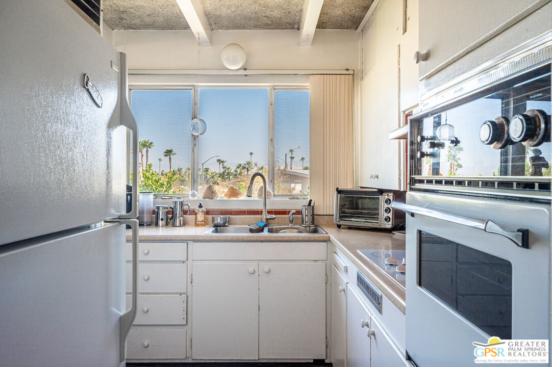 39910 Bird Lane Rancho Mirage, CA 92270 - Photo 6 of 45 a kitchen with a sink stove and cabinets