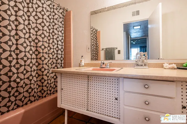 a bathroom with a sink a vanity and a mirror