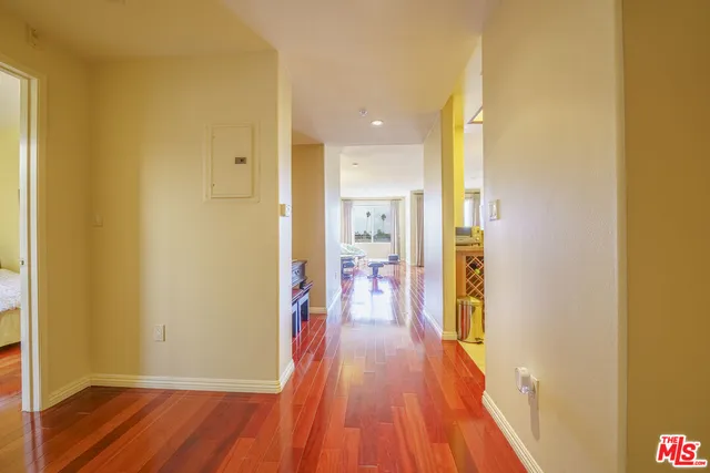 a view of a hallway with wooden floor