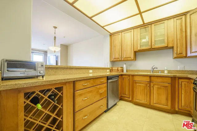 a kitchen with stainless steel appliances granite countertop a sink and cabinets