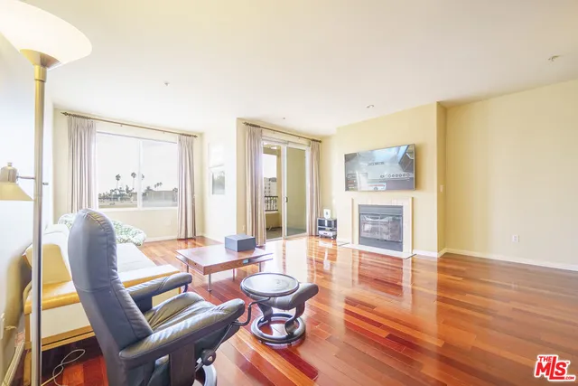 a living room with fireplace furniture and a table