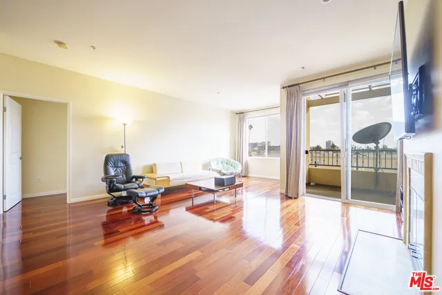 a living room with furniture window and wooden floor