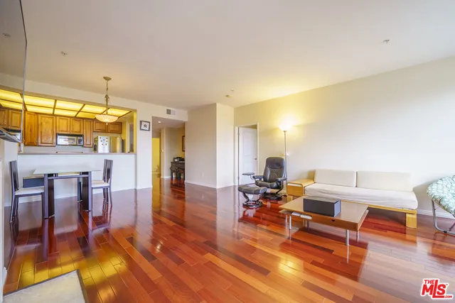 a living room with furniture a dining table and wooden floor