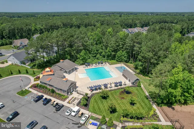 an aerial view of multiple houses with a yard