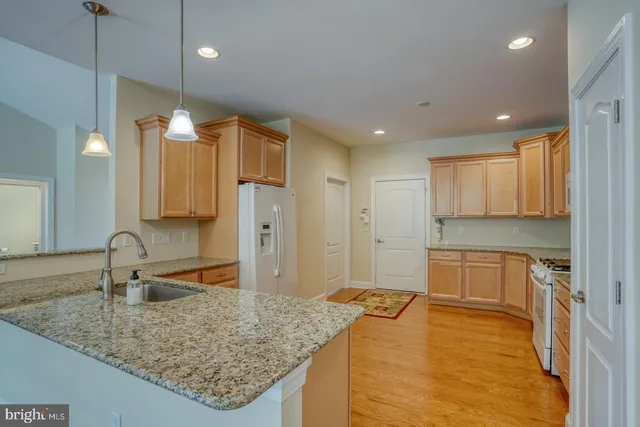 a bathroom with a granite countertop sink mirror vanity and toilet