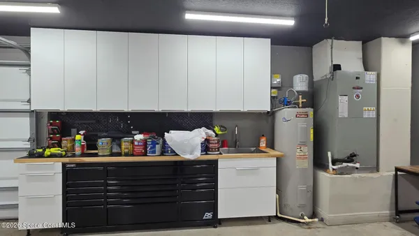 a kitchen with refrigerator and cabinets