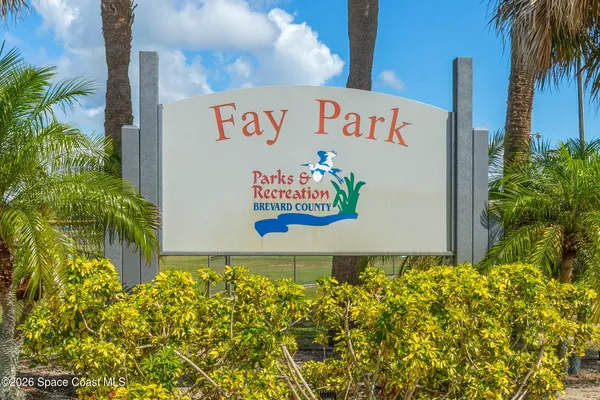 a sign that is in front of flowers