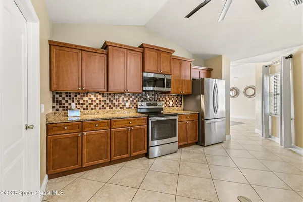 a kitchen with appliances cabinets and furniture
