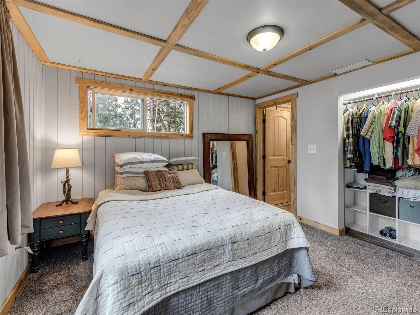 146 Dynamite Drive Black Hawk, CO 80422 - Photo 19 of 26 a bedroom with a bed and a flat tv screen on the dresser