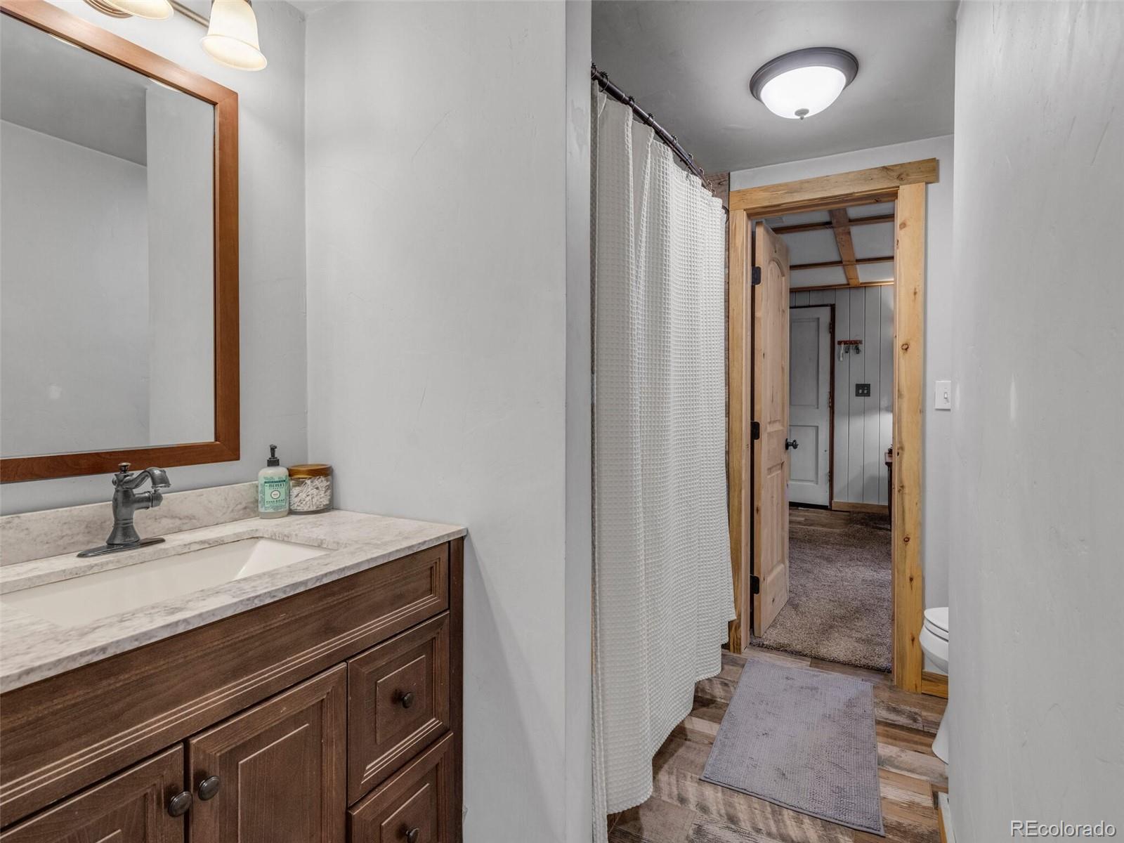 146 Dynamite Drive Black Hawk, CO 80422 - Photo 20 of 26 a en suite bathroom with a sink double vanity and a mirror