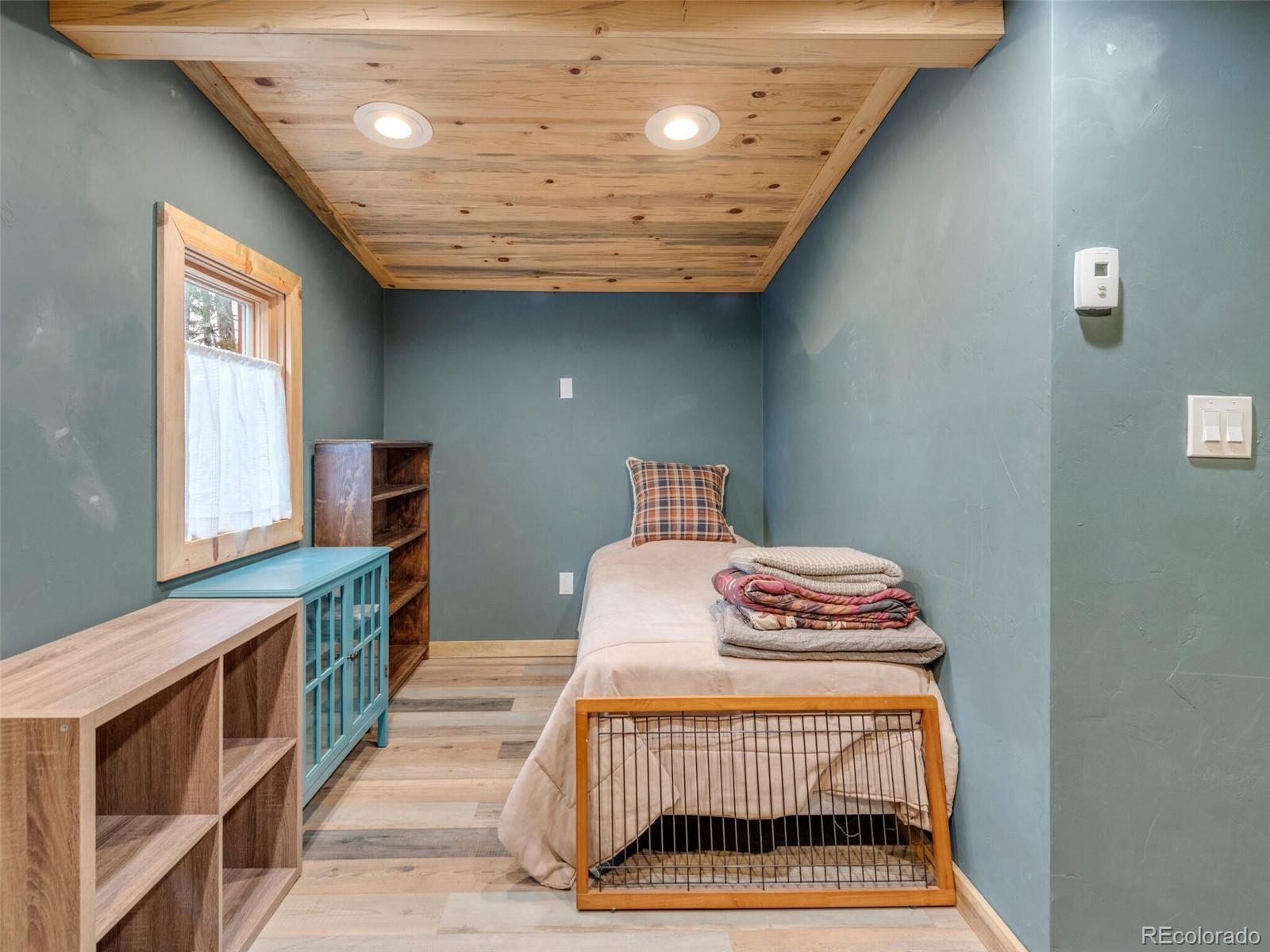 146 Dynamite Drive Black Hawk, CO 80422 - Photo 23 of 26 a bedroom with a bed and a window