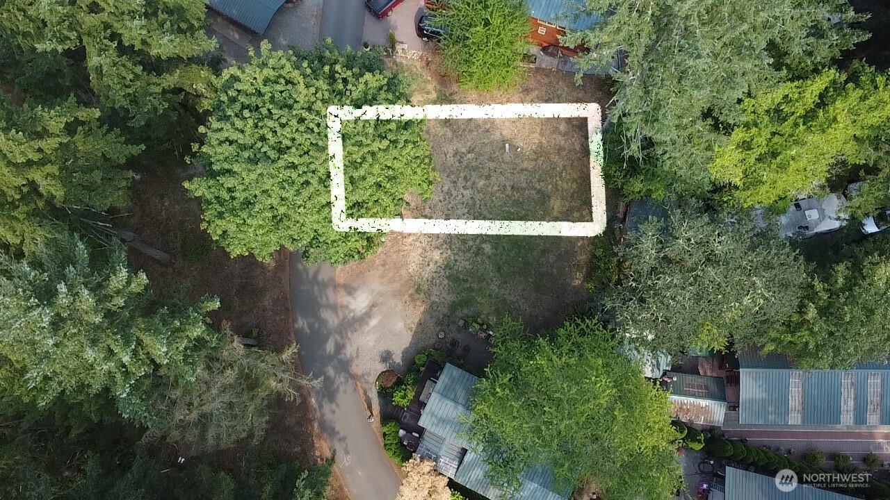 an aerial view of a house with a yard and garden