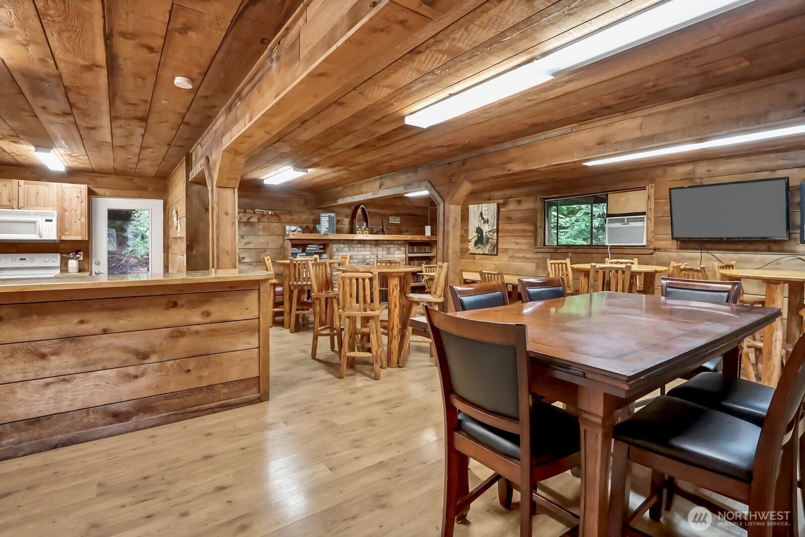 1546 Reservation Road Southeast, Unit 136 Olympia, WA 98513 - Photo 13 of 18 a dining hall with stainless steel appliances granite countertop a stove a sink a dining table and chairs with wooden floor