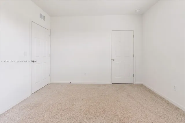 a big house with a big yard and large trees