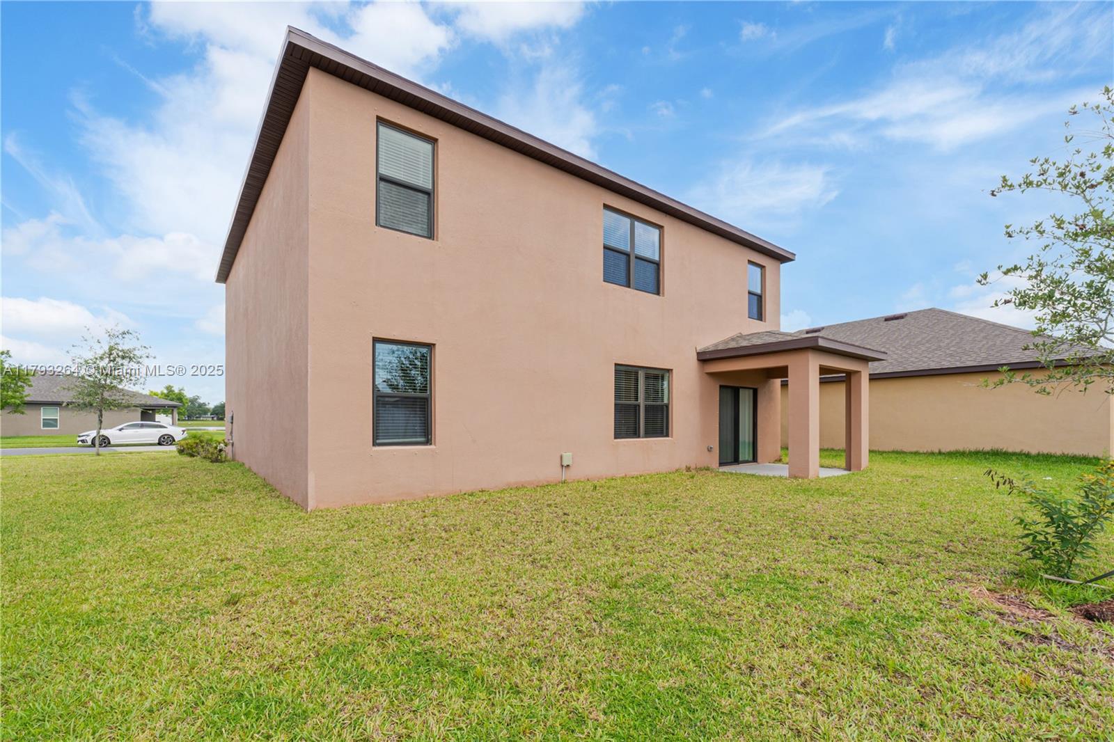 5305 Fantasy Drive Fort Pierce, FL 34947 - Photo 13 of 14 a big house with a big yard and large trees
