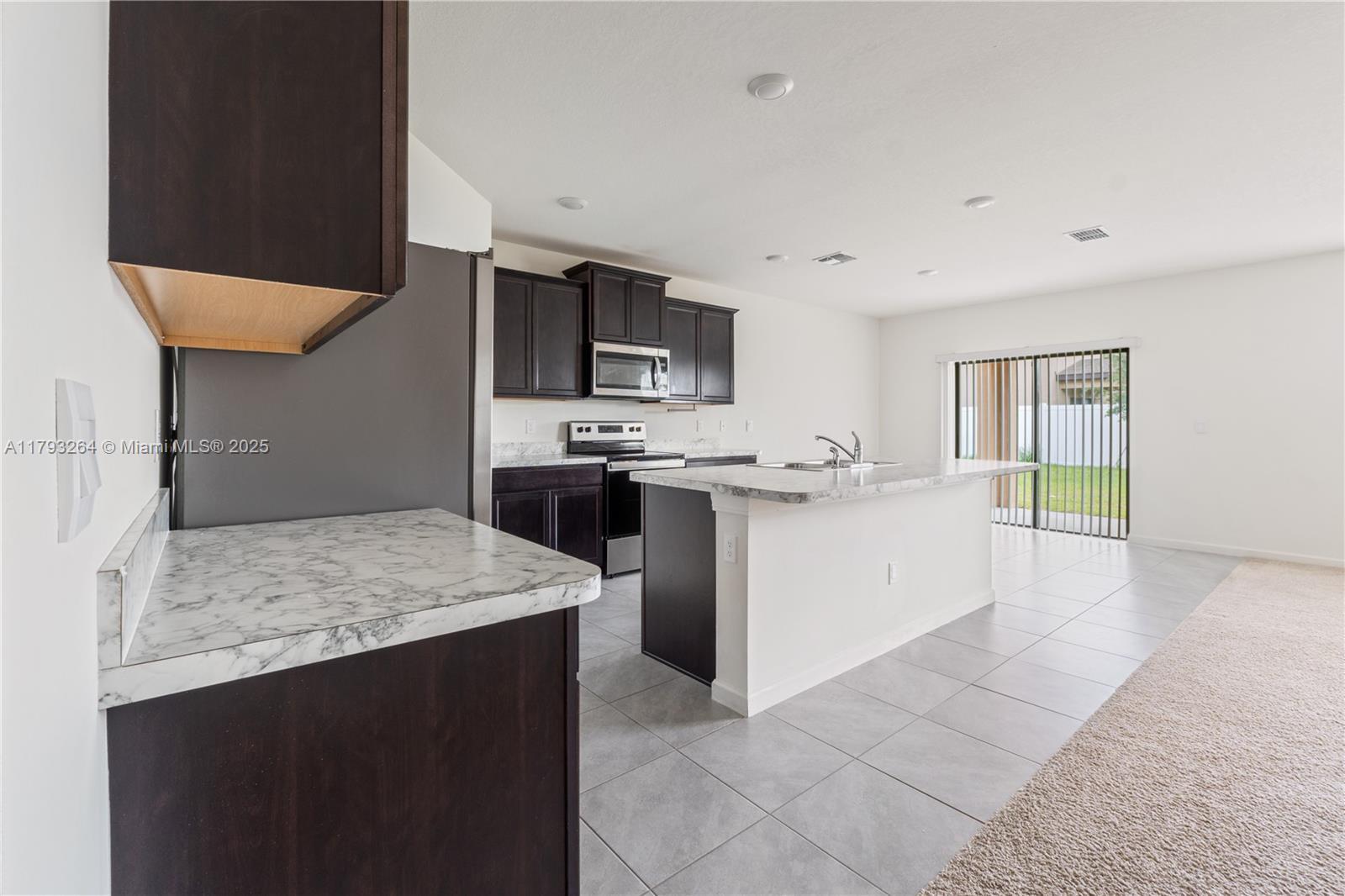 5305 Fantasy Drive Fort Pierce, FL 34947 - Photo 4 of 14 a kitchen with stainless steel appliances granite countertop a sink stove and refrigerator
