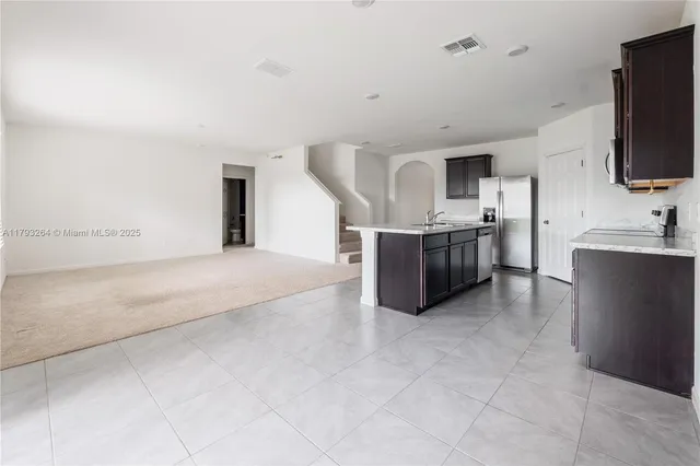 a large kitchen with cabinets and stainless steel appliances