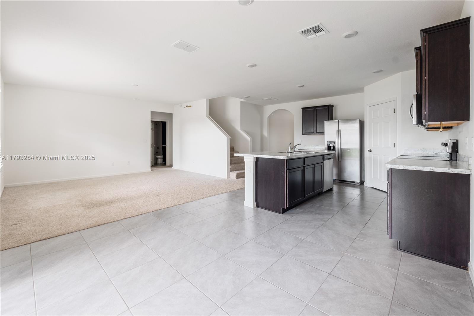 5305 Fantasy Drive Fort Pierce, FL 34947 - Photo 7 of 14 a large kitchen with cabinets and stainless steel appliances