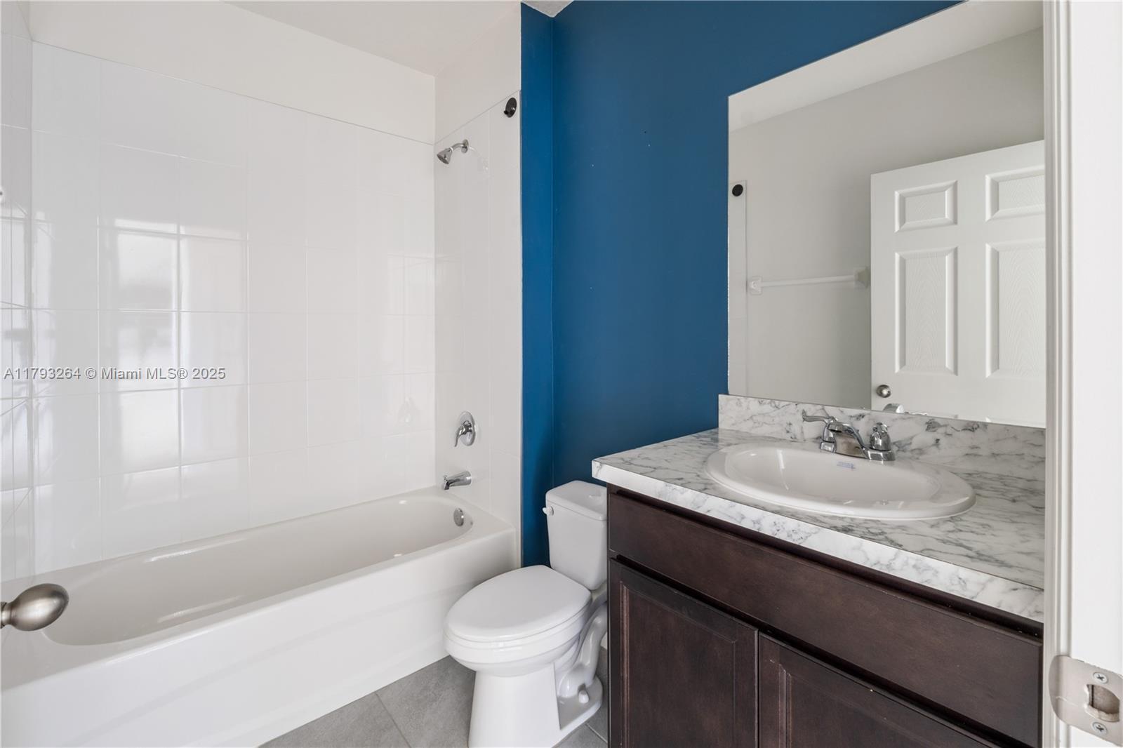 5305 Fantasy Drive Fort Pierce, FL 34947 - Photo 9 of 14 a bathroom with a granite countertop sink toilet and shower