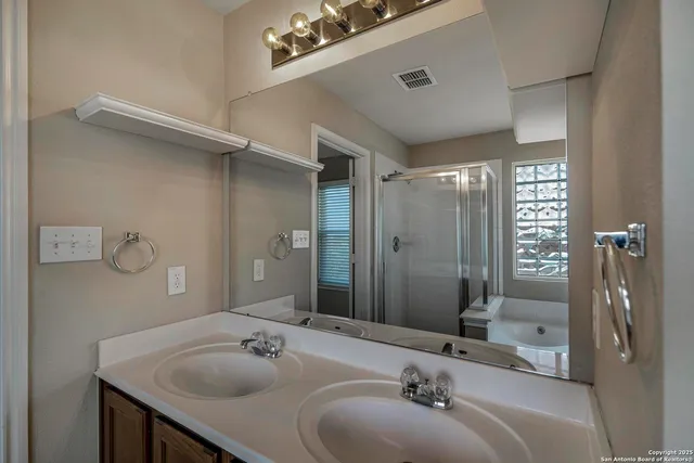 a bathroom with a sink a mirror and shower