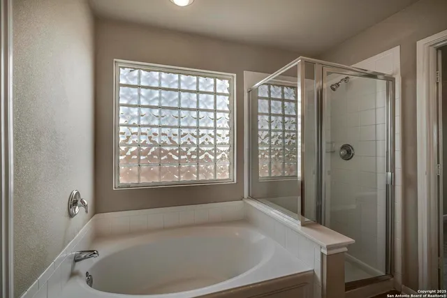 a bathroom with a tub and shower