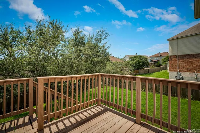 a view of balcony with wooden floor and fence