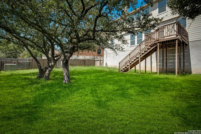 a view of house with backyard