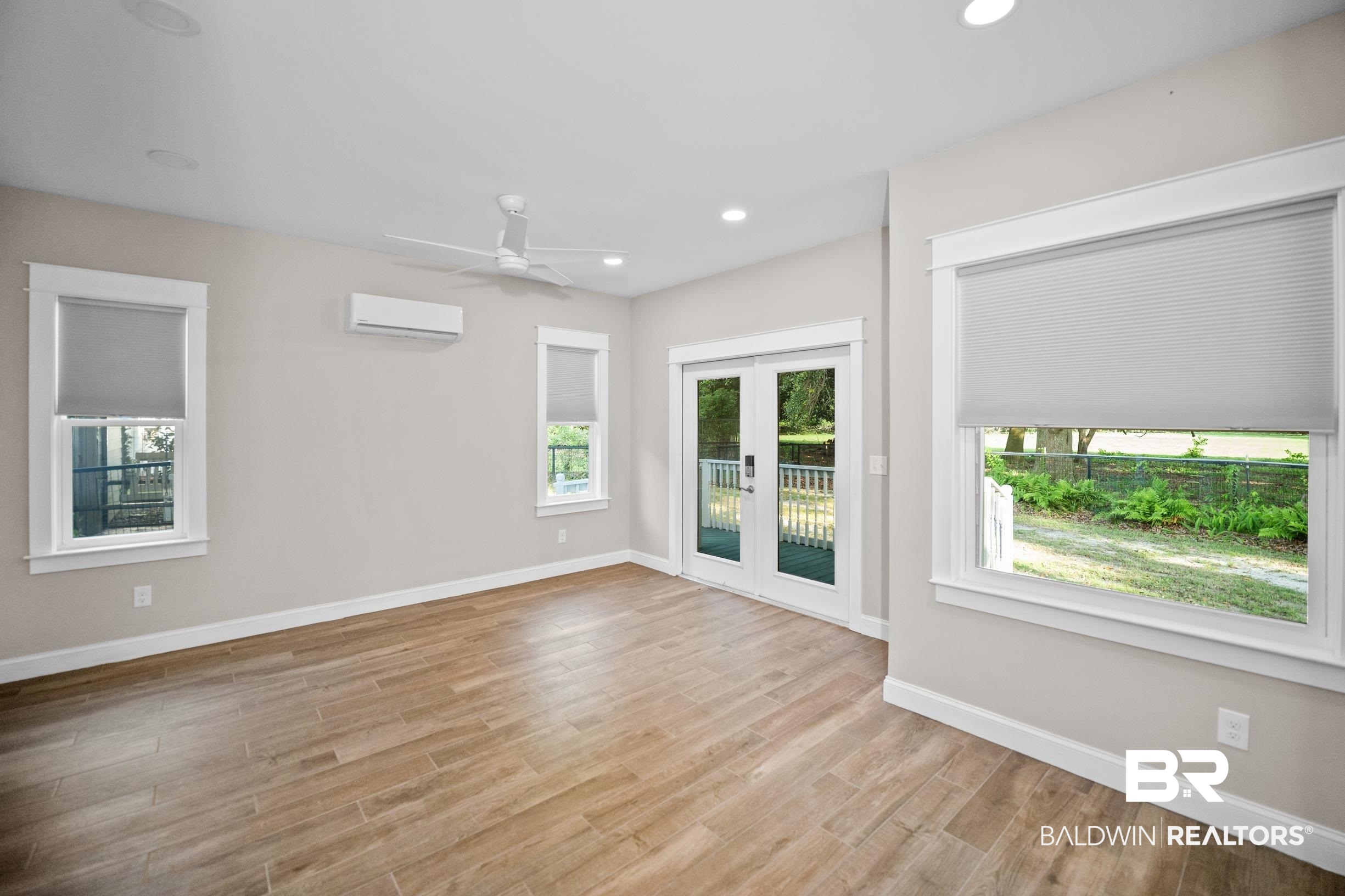 12254 Reunion Place Foley, AL 36535 - Photo 40 of 62 Unfurnished room with a wall mounted air conditioner, light wood-style floors, baseboards, a ceiling fan, and recessed lighting
