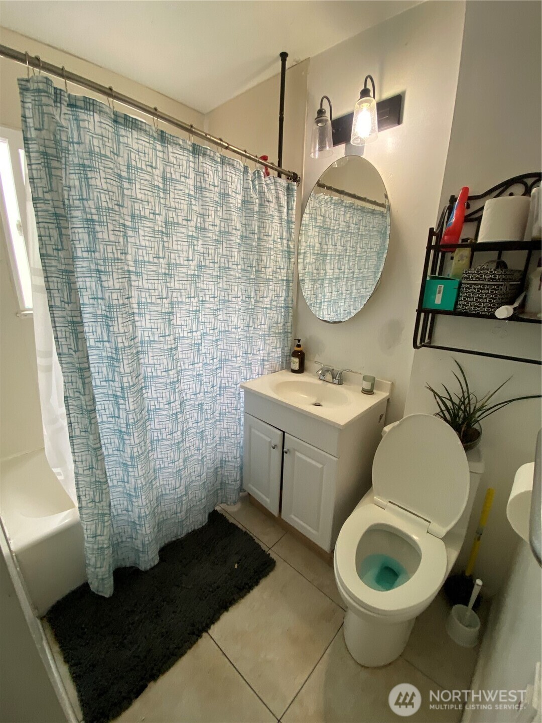 3625 15th Avenue South Seattle, WA 98144 - Photo 7 of 10 a bathroom with a sink toilet a mirror and vanity
