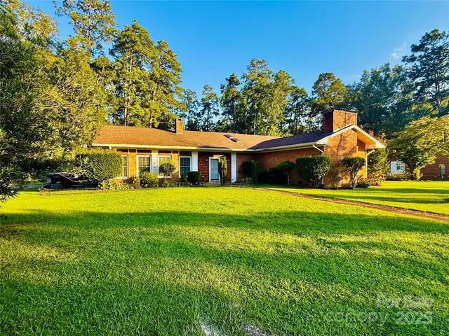 a view of house with a garden