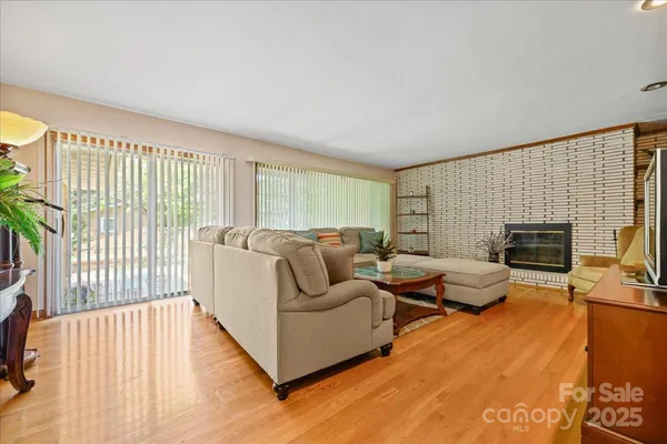 a living room with furniture fireplace and a flat screen tv