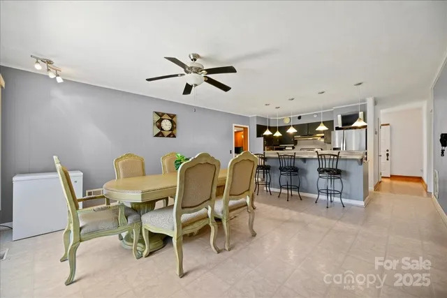 a view of a dining room with furniture and a chandelier